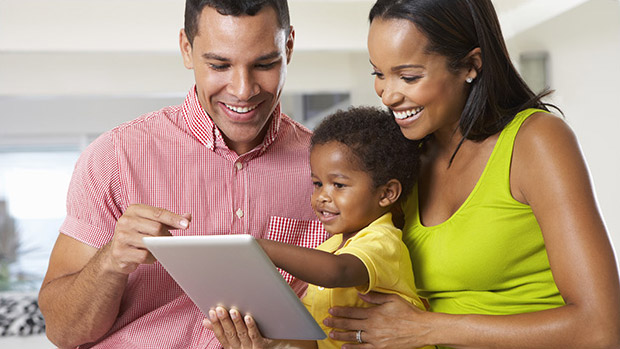 A family happily looking for offers on their tablet.