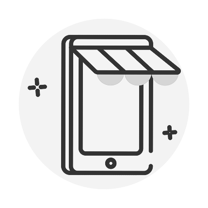 A woman sits against a white background, working on her laptop.